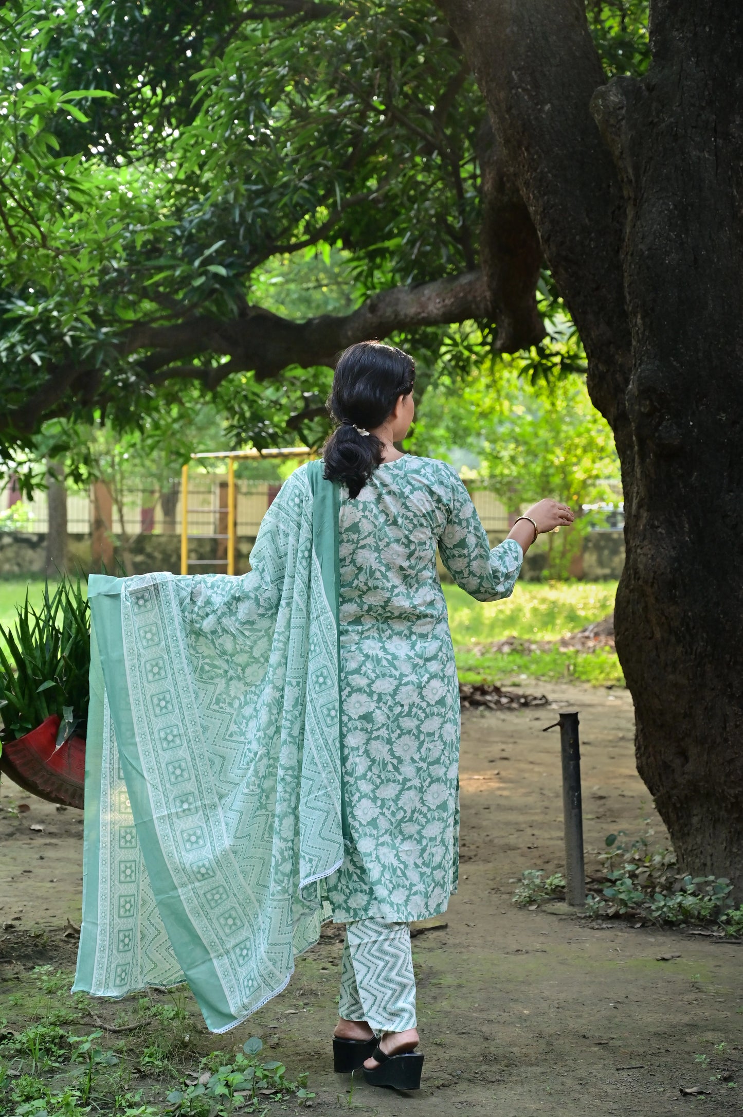 Back view of dusty Mint green cotton kurta set with floral patterns and matching dupatta for casual wear.