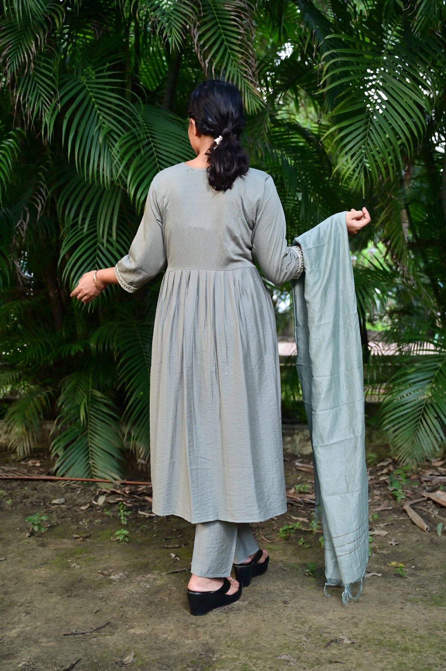 Back view of sage green Anarkali kurta set with muslin fabric