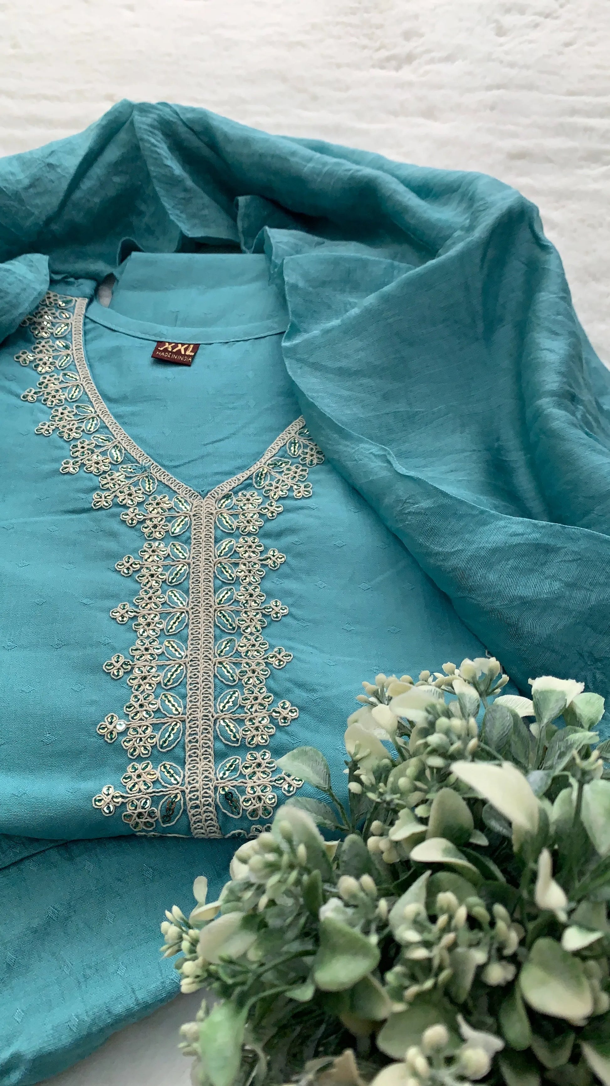 Close up of Teal blue Anarkali kurta set with matching dupatta and embroidery