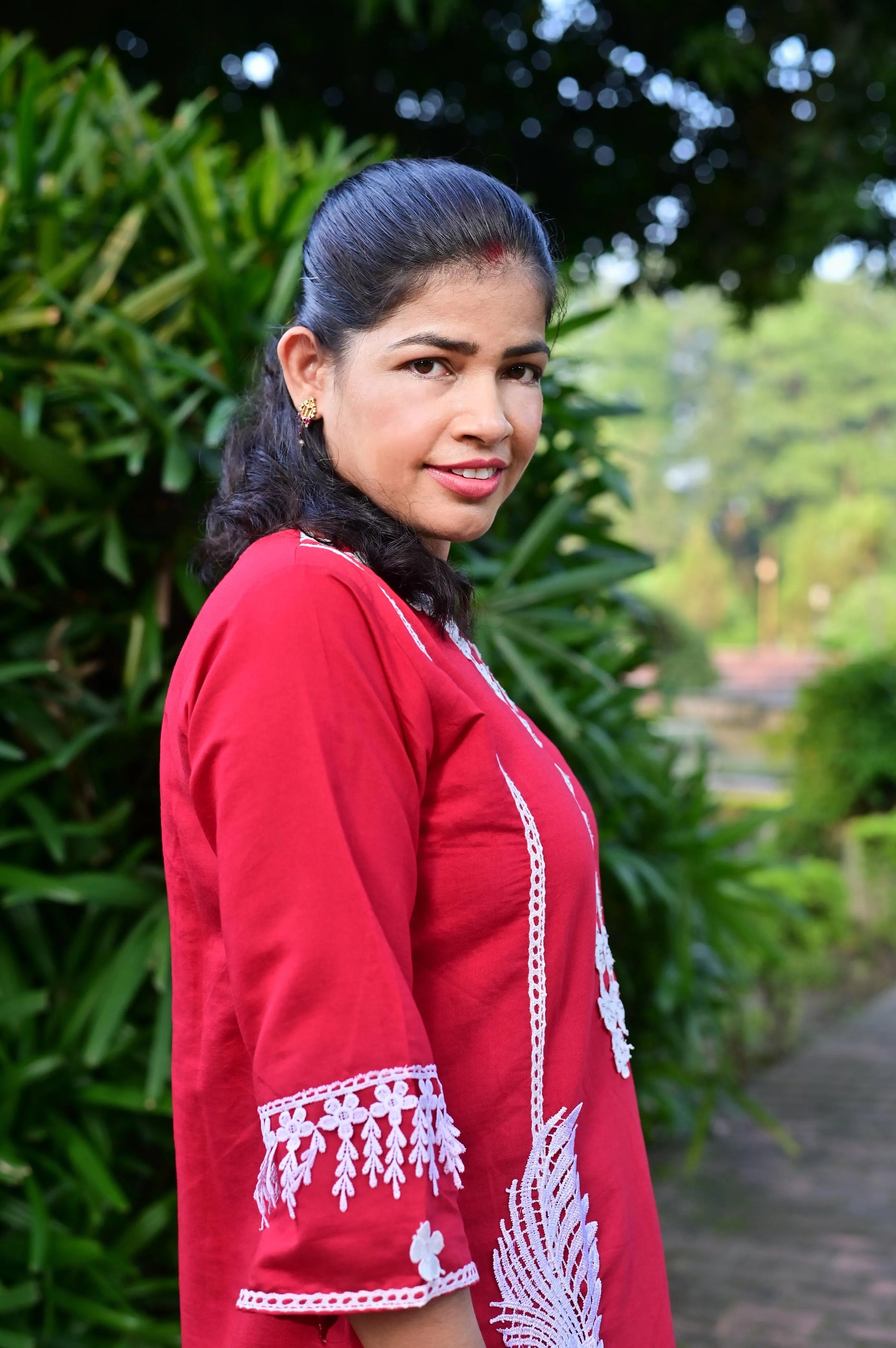 Close-up of red kurta with white embroidery and cotton blend fabric