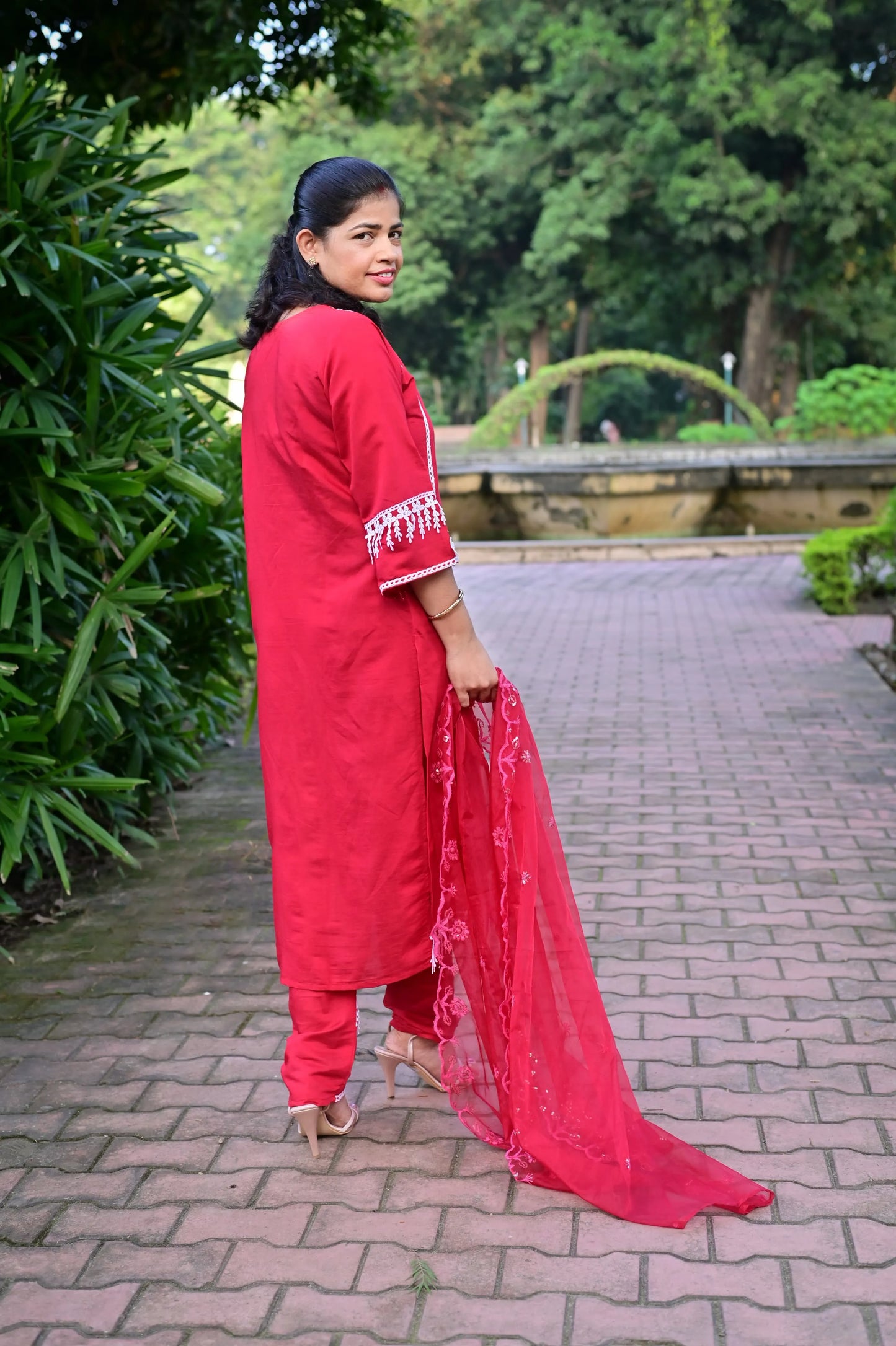 Back view of red kurta pant set with white embroidery and net dupatta