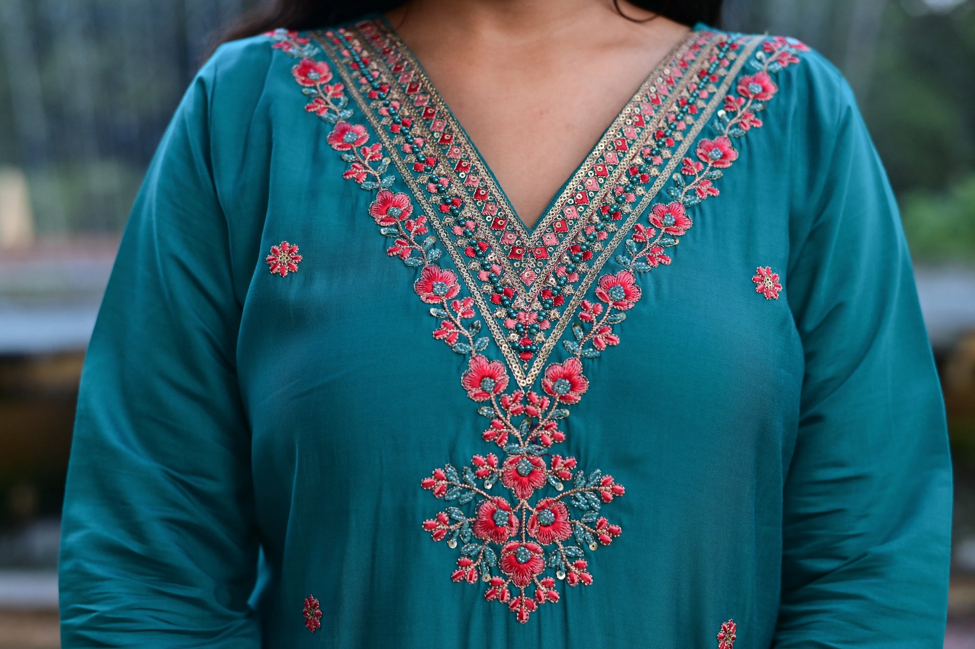 Teal green roman silk 3-piece suit with floral embroidered neckline and printed dupatta closeup