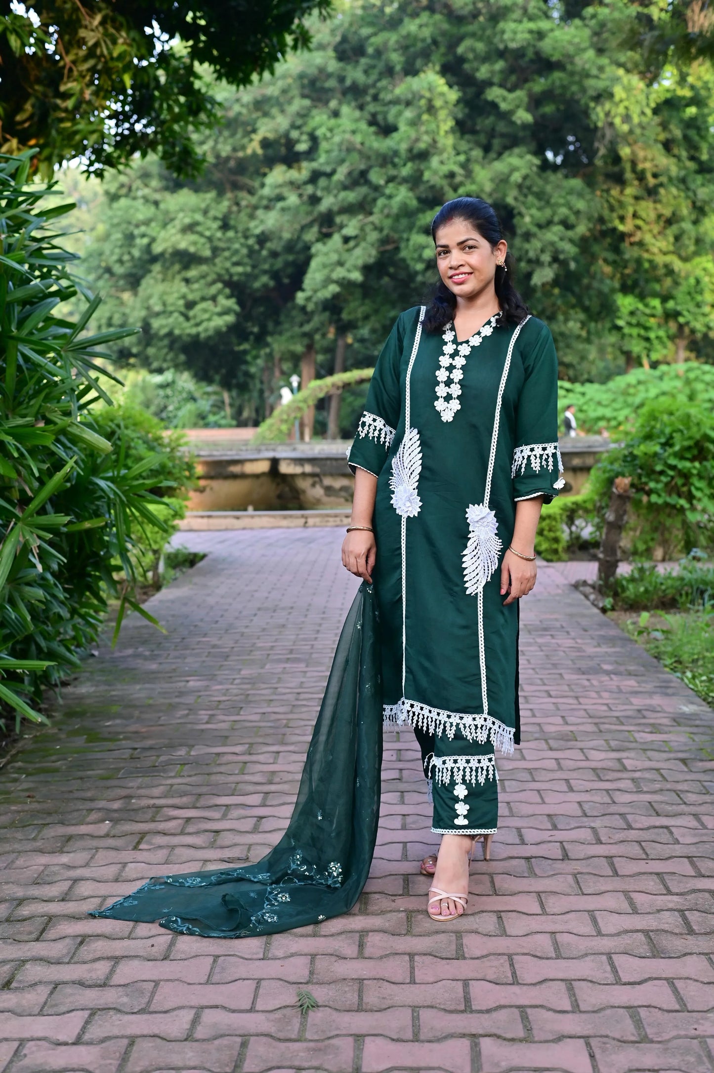 Elegant green kurta pant set with embroidered details, styled with matching net dupatta